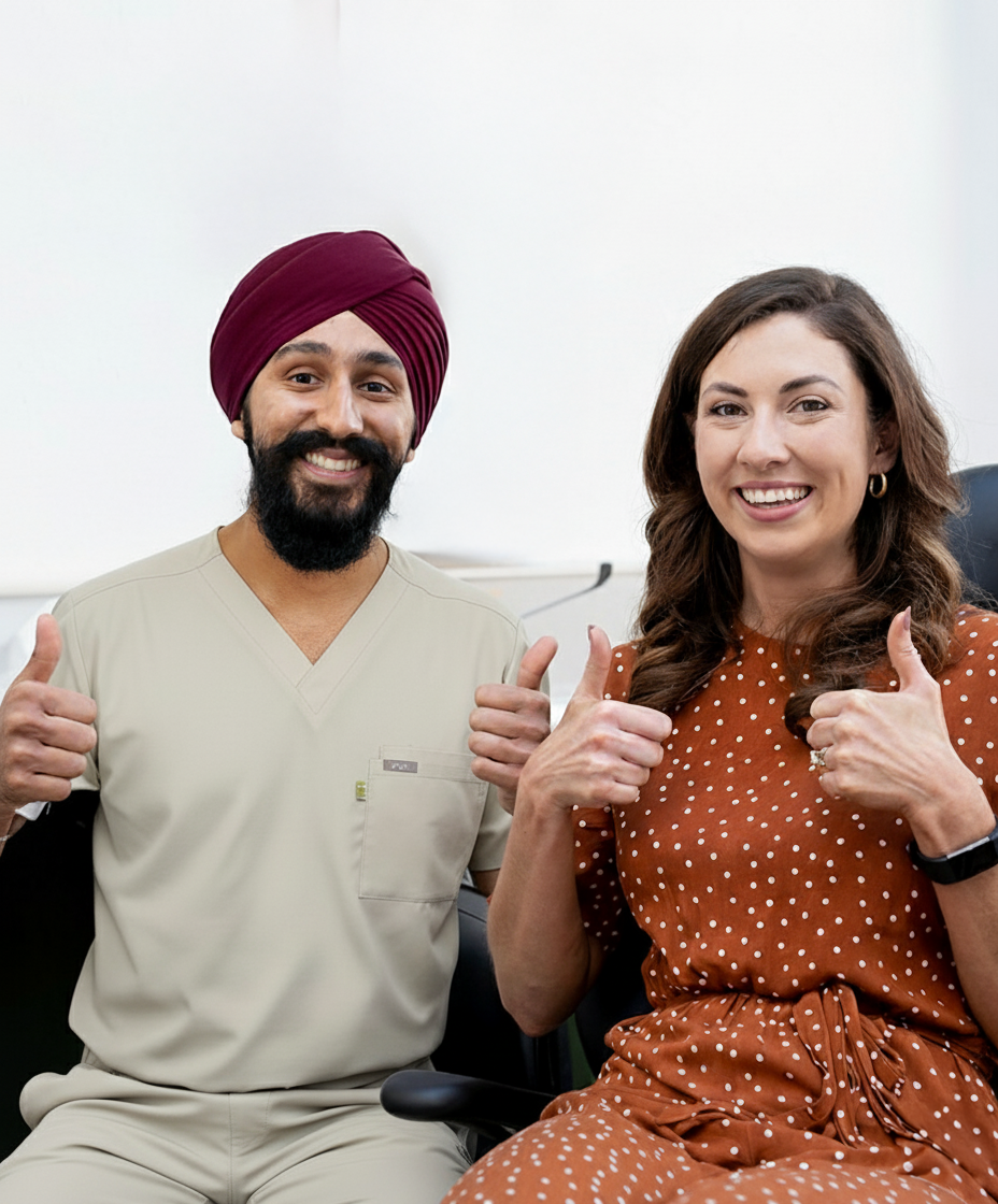 Dr. Karm Jandoo with a happy patient showing off their new smile after successful treatment